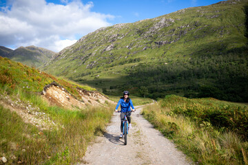 Fototapeta premium Cyclist exploring scenic mountain trail.