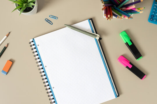 flat lay blank of a blank spiral notebook on desk with stationery mockup template