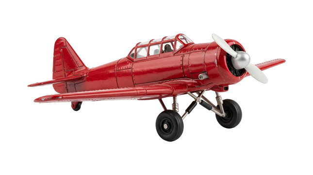 Miniature red vintage propeller airplane model isolated on transparent background for flight collection.