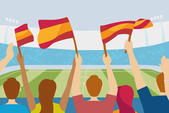 Fans wave Spanish flags while watching a soccer match in a stadium during the day in a crowded sports event