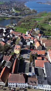 Aerial summer view of Haderslev city with historic rooftops and the lake beautifully visible in the background
