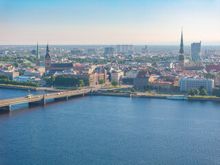 Obraz premium Aerial panoramic view of Riga Old Town skyline, Riga Cathedral and St. Peter’s Church across the Daugava River, Latvia