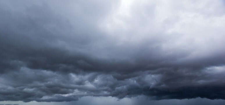 Bad or moody weather sky and environment. The dark sky with heavy clouds converging and a violent storm before the rain. global warming, climate change.