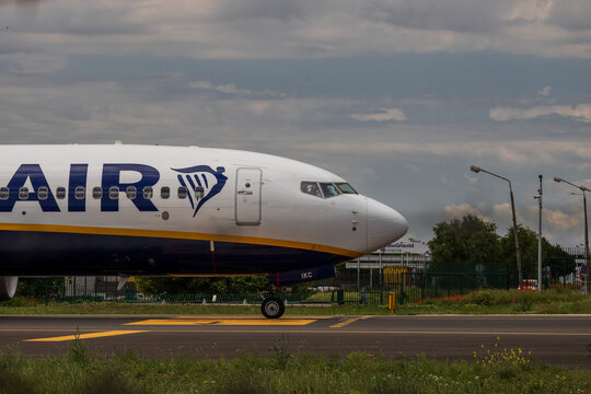 Ryan Air commercial passenger airplane taxiing on the asphalt tarmac and takeoff at an airport runway in Romania