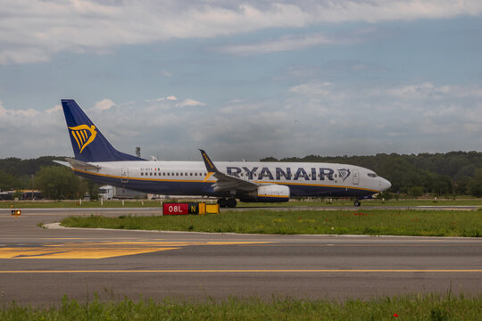Ryan Air commercial passenger airplane taxiing on the asphalt tarmac and takeoff at an airport runway in Romania