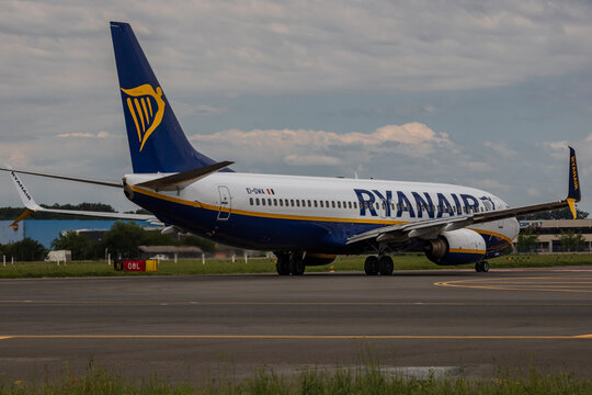 Ryan Air commercial passenger airplane taxiing on the asphalt tarmac and takeoff at an airport runway in Romania