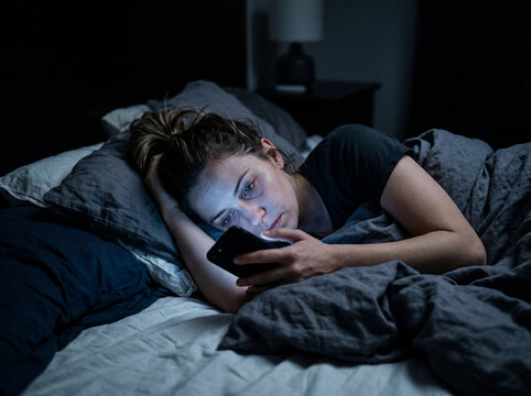 Woman Using Smartphone Late at Night Showing Digital Addiction Concept
