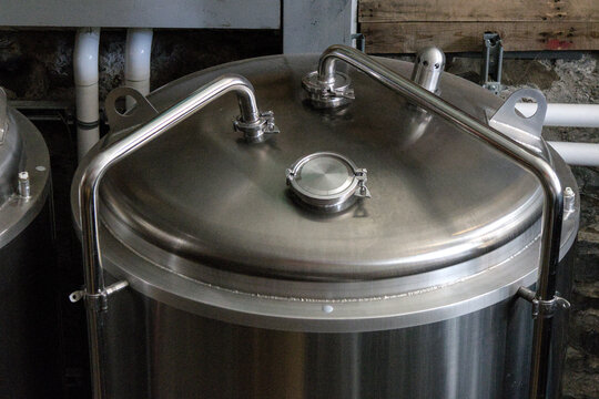 brewery fermentation containers close up fermenter bright tank stainless steel pipe pressure dispensing conditioning fermenting vessel beer ale brewing process transfer lager lagering modern