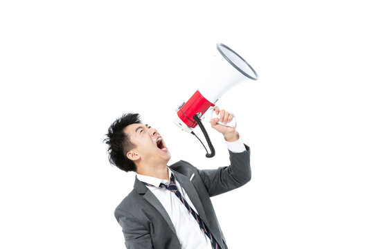 Businessman shouting through megaphone on white background