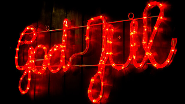 God jul red neon light sign glowing at night