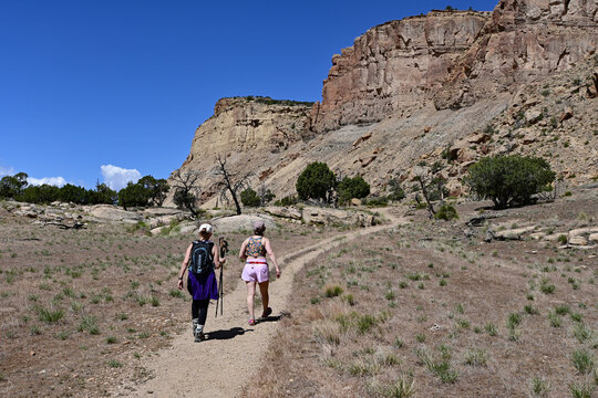 Two women hikers ascending Mount Garfield trail near Palisade and Grand Junction in Mesa County, Colorado on sunny clear morning.