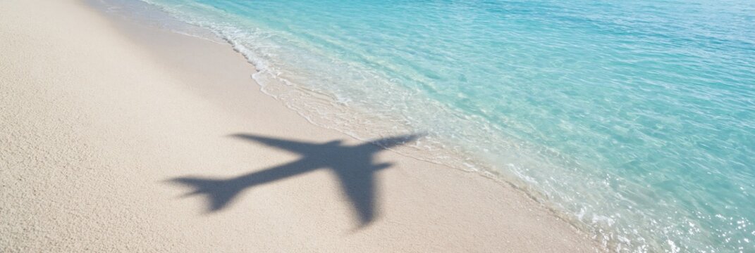 airplane shadow on sandy beach