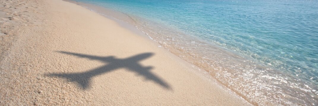 airplane shadow on sandy beach