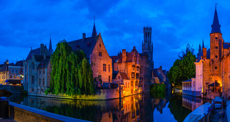Fototapeta premium Panorama Bruges cityscape, Brugge old town panoramic view, Rosary Quay, Bourgondisch Cruyce, Belfort tower, De groote Hollander, water canal, evening view, West Flanders province, Belgium