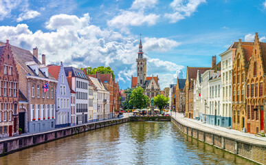 Fototapeta premium Bruges cityscape, Panoramic view of Brugge old town, Bruges city historic centre, water canal, Poortersloge tower, King's Bridge and medieval buildings on embankment, West Flanders province, Belgium