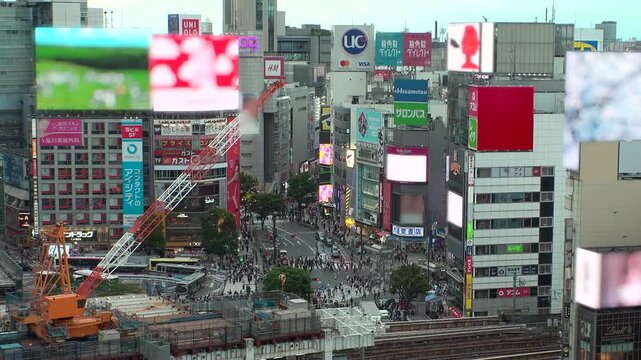 TOKYO, JAPAN - JUNE 2026 : Aerial view of Shibuya city in sunset. View of buildings and streets at downtown area. Japanese urban city and travel concept video. Time lapse shot, dusk to night.