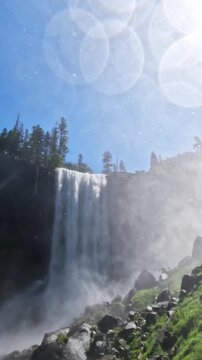 Vernal Fall waterfall in Yosemite National Park, California, featuring rushing water, granite cliffs, forest scenery, and pristine wilderness landscapes