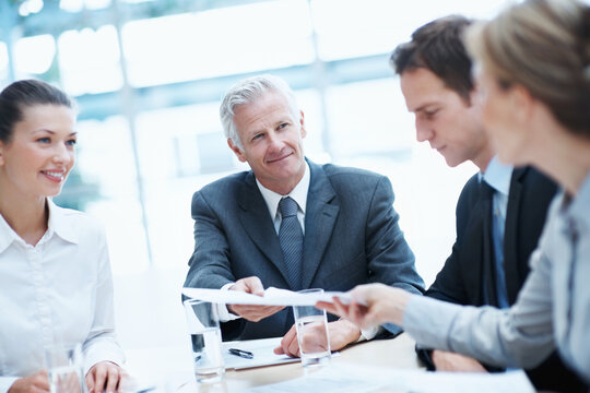 Corporate, meeting and business people in office with documents, manager and handover for budget review. Accounting, management and team in firm with paperwork, collaboration and financial planning.