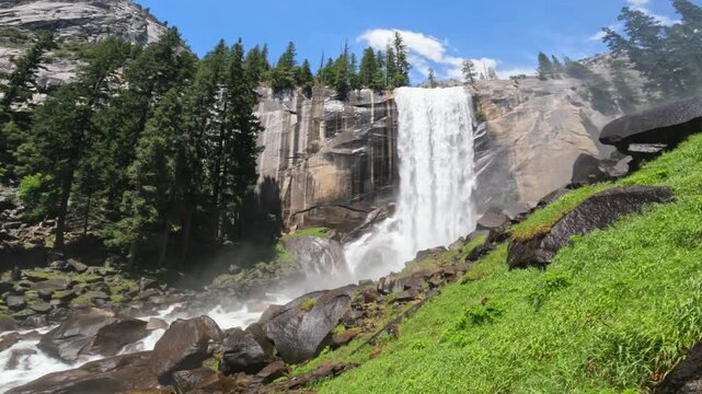 Vernal Fall waterfall in Yosemite National Park, California, featuring rushing water, granite cliffs, forest scenery, and pristine wilderness landscapes