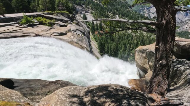 Breathtaking footage captured at the top of Nevada Fall, where the Merced River rushes across smooth granite before plunging into the canyon below