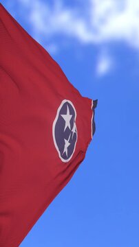 Waving Tennessee State Flag Against Bright Blue Sky