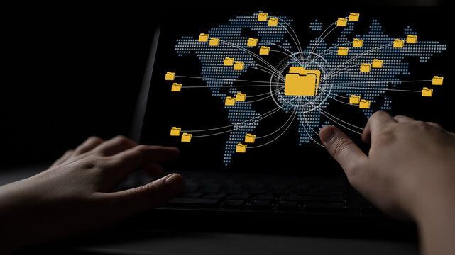 Global Digital Connectivity and Networked Data Transfer Represented by File Icons on Computer Screen with Human Hand Reaching Out Fluxor.