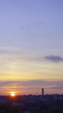 Birmingham City Skyline Eastside Sunrise Timelapse, Vertical Format 
Time-lapse video capturing a dramatic golden sunrise breaking over the Eastside district skyline of Birmingham, United Kingdom.  