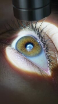 Vertical video: Shining penlight over right eye pulling lid making corneal dot for exam, copy space