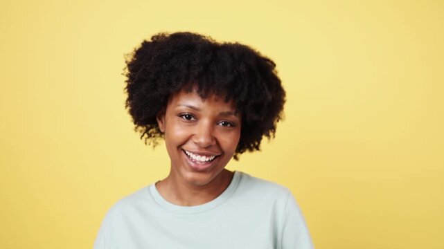 Young woman showing different facial expressions on yellow background