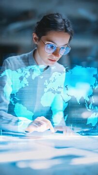 Confident female professional interacts with a glowing virtual screen, analyzing information in a high tech workspace. Digital transformation and smart solutions for future industries are depicted