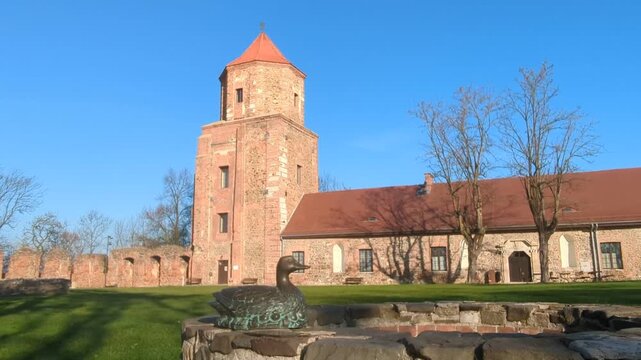 Sculpture associated with legend of golden duck in front. Castle Tower in background. Toszek, Poland.