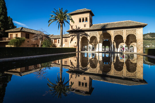 Partal Palace with symmetrical reflection in the large pool at the Alhambra in Granada Spain