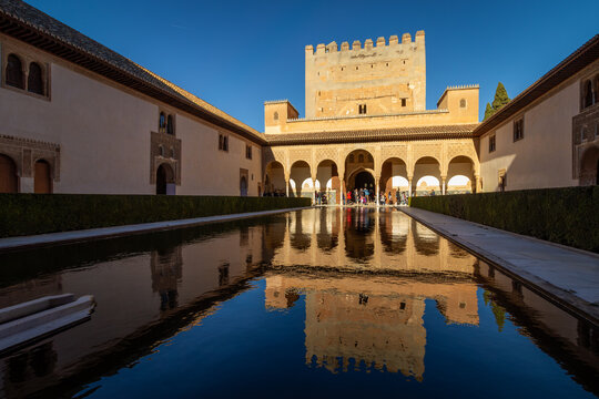 Court of the Myrtles with Comares Tower reflecting in the central pool at the Nasrid Palaces Alhambra