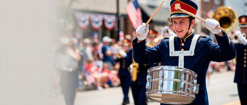 Young man drummer in marching band performing during Independence Day parade. Musician playing snare drum on Independence Day celebration. American patriotic event and holiday performance.