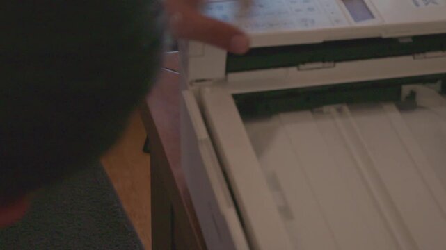 Man repairing a malfunctioning office printer