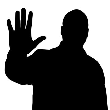 Silhouette of a man with his hand raised in a stopping motion