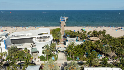 Aerial view of the iconic Pompano Beach Pier stretching into the Atlantic Ocean, surrounded by palm-lined beaches and South Florida's vibrant waterfront. © Noah Densmore