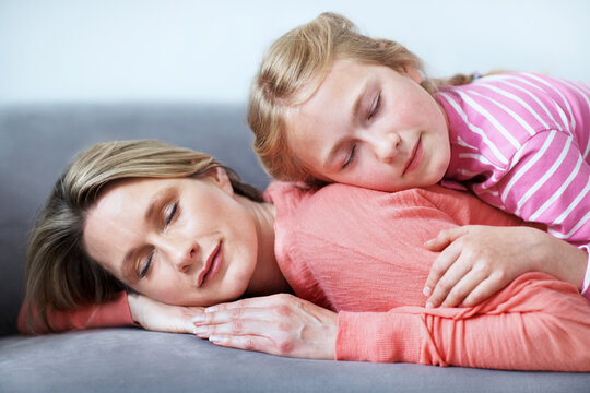 Mother, daughter and sleeping in home with couch, comfortable and bonding together on weekend break. Woman, child and nap in living room with sofa, family connection and single parent relax with kid.