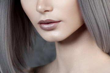 Fototapeta premium Woman displaying lower face and neck in studio closeup with smooth skin