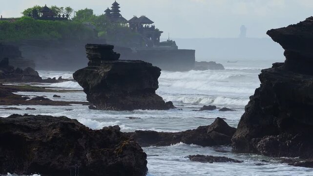 Rough Waves Rocky Coastline Tanah Lot Temple Silhouette With Pounding Surf, Windblown Spray And Bouldered Foreground, Dramatic Clouds, High Tide Motion, Cinematic Seascape For Travel And Storm Footage
