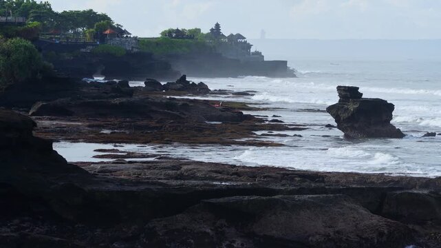 Rough Waves Rocky Coastline Tanah Lot Temple Silhouette With Pounding Surf, Windblown Spray And Bouldered Foreground, Dramatic Clouds, High Tide Motion, Cinematic Seascape For Travel And Storm Footage