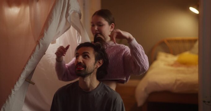 Young woman styling a man&rsquo;s hair in a cozy bedroom hideout