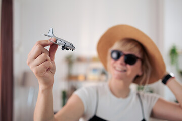 Woman holding toy airplane planning dream travel vacation © MexChriss