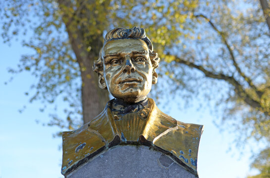 Bronze bust of Johan Hendrik van Dale, founder or the most famous Dutch dictionary, with tree in the back, in his birthplace Sluis in The Netherlands