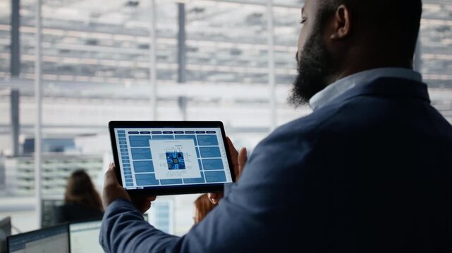 Examining microchip circuit layouts, tablet close up and engineer in factory office, improving semiconductor manufacturing, device app and R&D workspace for semiconductor research.