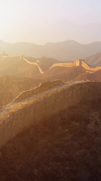 Flying over the Great Wall of China at sunrise. Vertical Video,