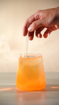 stir orange astaxanthin in a glass of water