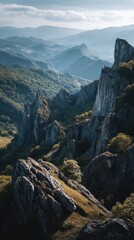 Obraz premium Dramatic rugged rock formations cascading through a lush mountainous forest landscape under soft sunlight with misty blue hills in the distant horizon on a cloudy da