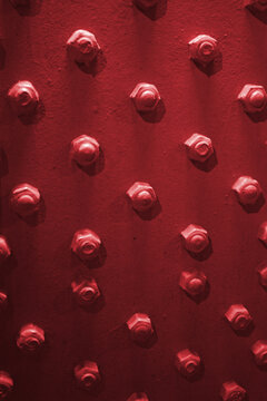 Red Lug Bolts on a Red Wall