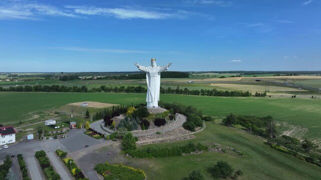 Aerial Christ the King statue Poland pull 2. King of the Universe in Swiebodzin, Poland, completed 2010. 33 meters, symbol of Jesus age at his death. Pilgrimage and tourist extraordinary.
